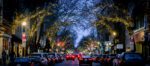 Evening streetscape with twinkling lights in trees
