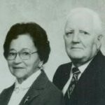 black and white photo of woman with glasses and white haired man