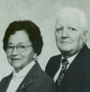 black and white photo of woman with glasses and white haired man