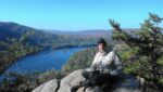 Man atop rock in the mountains